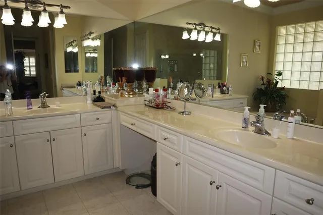 a bathroom with double sink and a mirror