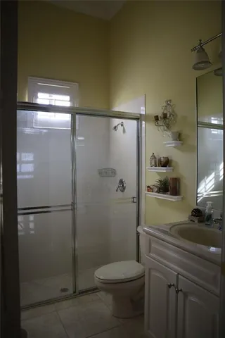 a bathroom with a toilet a sink and shower