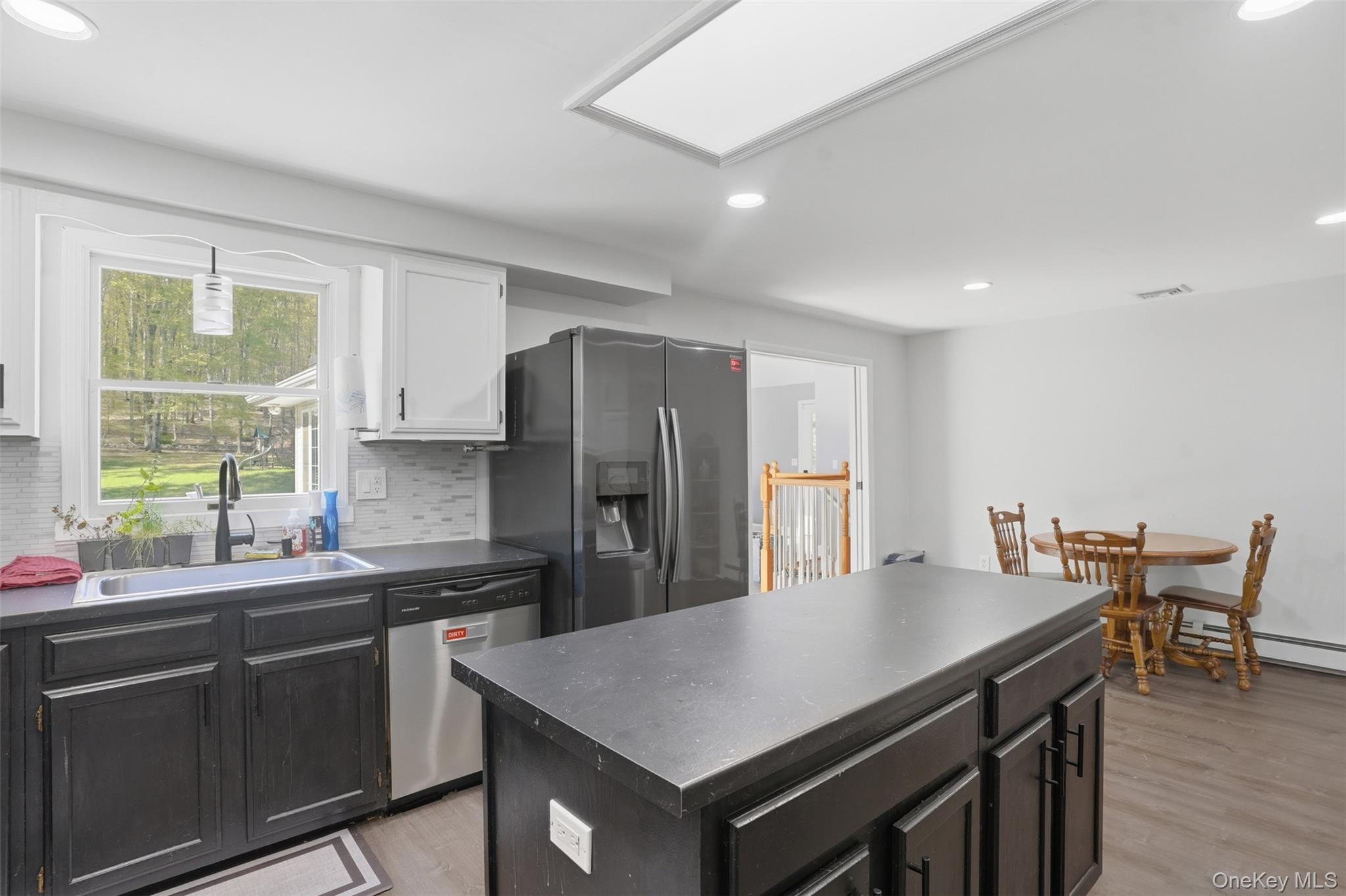 65 Judson Road Montgomery, NY 12549 - Photo 20 of 41 a kitchen with stainless steel appliances a kitchen island a stove a table and a refrigerator