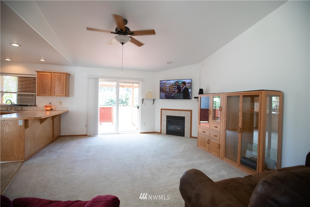 4129 Coomer Lane Southwest Rochester, WA 98579 - Photo 18 of 31 a living room with furniture and a fireplace