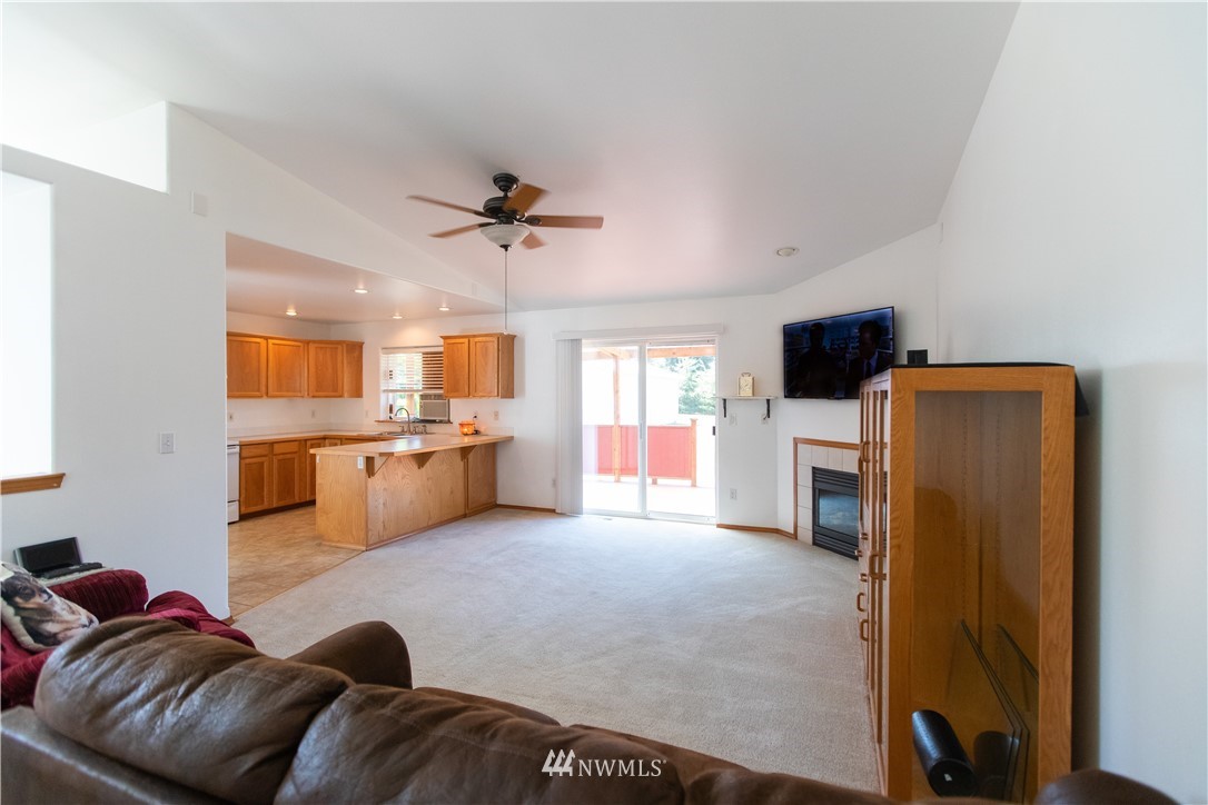 4129 Coomer Lane Southwest Rochester, WA 98579 - Photo 20 of 31 a living room with furniture a flat screen tv and kitchen view