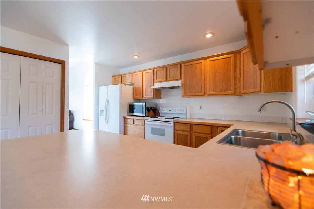 4129 Coomer Lane Southwest Rochester, WA 98579 - Photo 23 of 31 a kitchen with stainless steel appliances granite countertop a sink stove and refrigerator