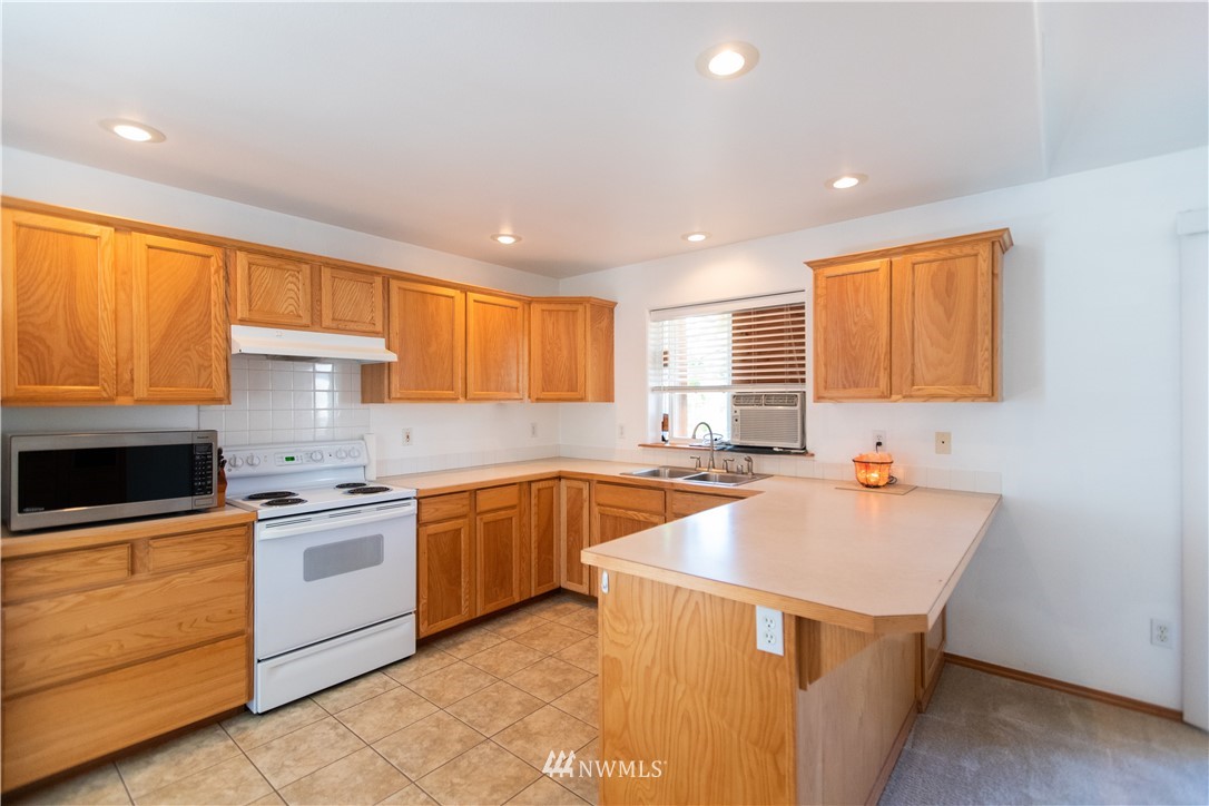 4129 Coomer Lane Southwest Rochester, WA 98579 - Photo 24 of 31 a kitchen with stainless steel appliances a sink stove and cabinets
