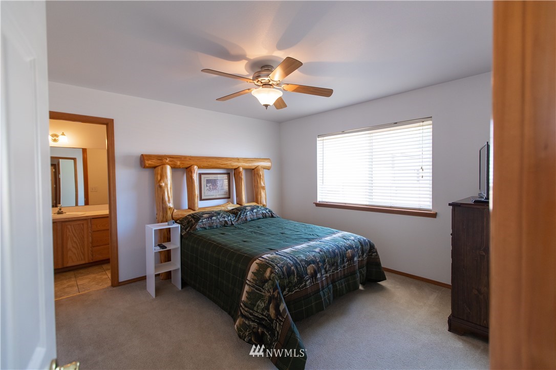 4129 Coomer Lane Southwest Rochester, WA 98579 - Photo 25 of 31 a bedroom with a bed and a window