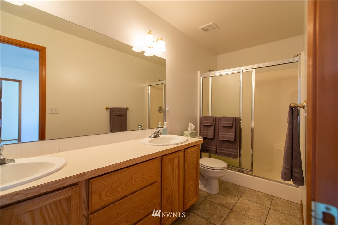 4129 Coomer Lane Southwest Rochester, WA 98579 - Photo 27 of 31 a spacious bathroom with a sink a toilet a mirror and shower