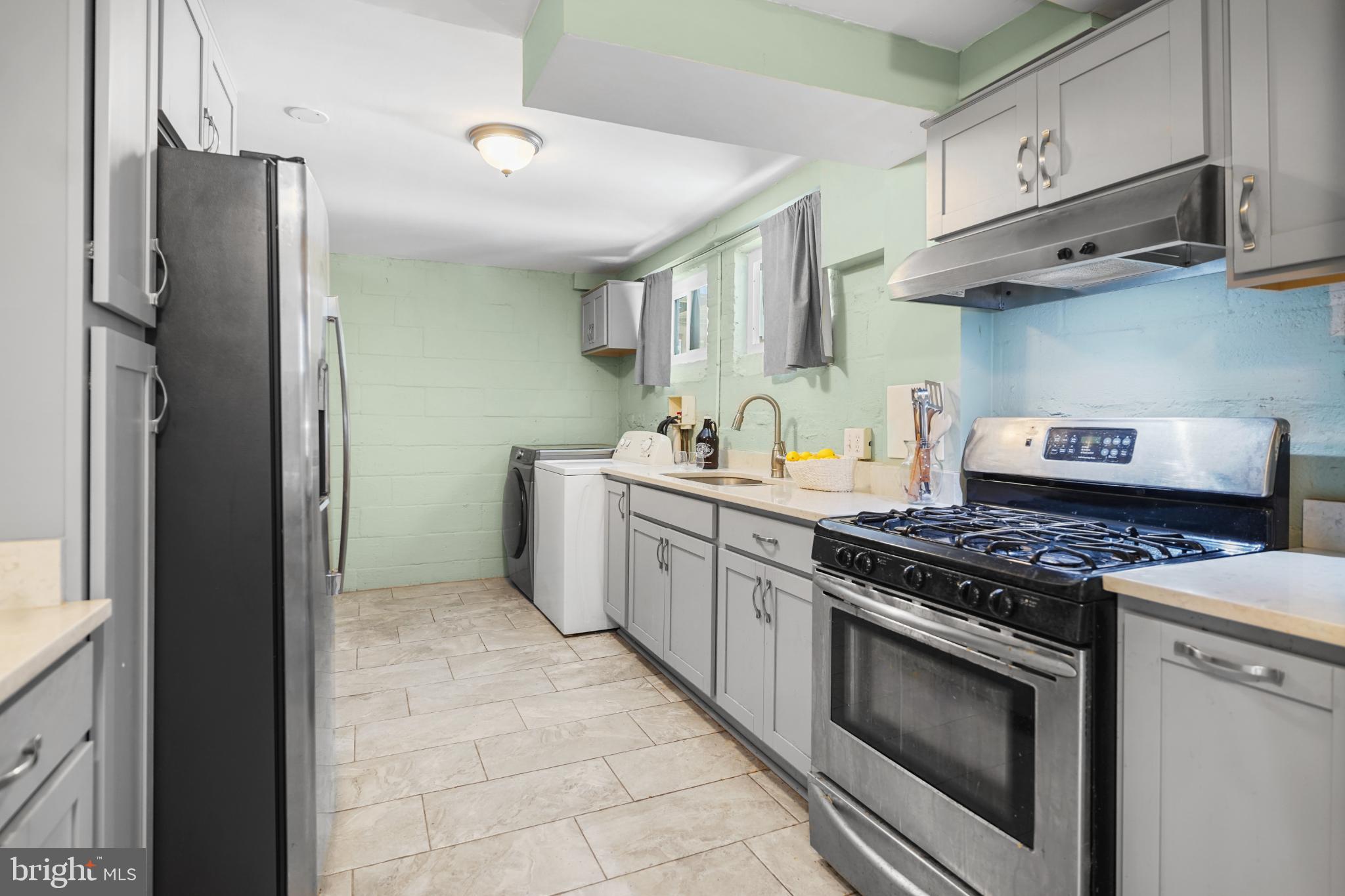 1790 Verbena Street Northwest Washington, DC 20012 - Photo 28 of 31 a kitchen with stainless steel appliances granite countertop a stove and a refrigerator