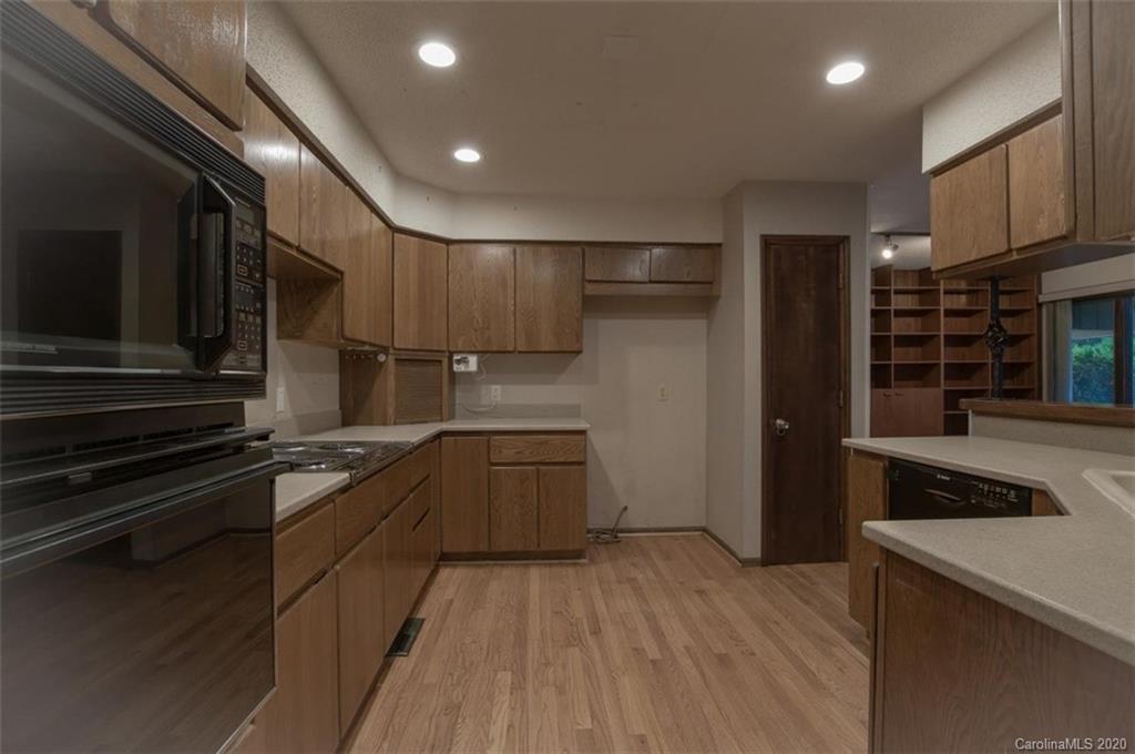 5220 Rounding Run Road, Unit 159 Charlotte, NC 28277 - Photo 36 of 42 a kitchen with stainless steel appliances granite countertop a refrigerator and a stove top oven