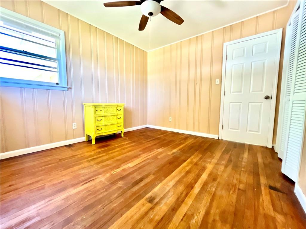 119 Fifth Avenue Jonesboro, GA 30236 - Photo 9 of 29 a view of an empty room with a window and wooden floor