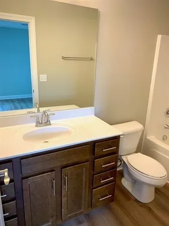a bathroom with a sink a toilet and vanity