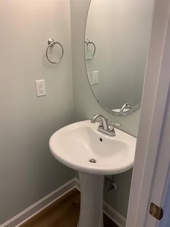 a bathroom with a sink a mirror and shower