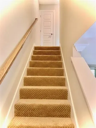 a view of staircase with white walls