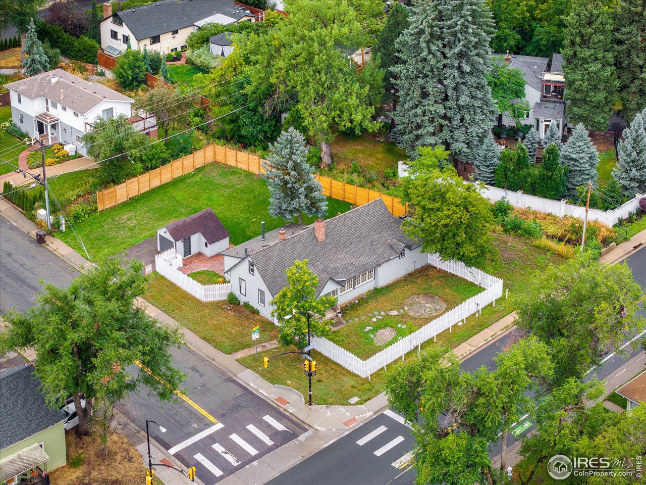 an aerial view of a house with a garden and swimming pool