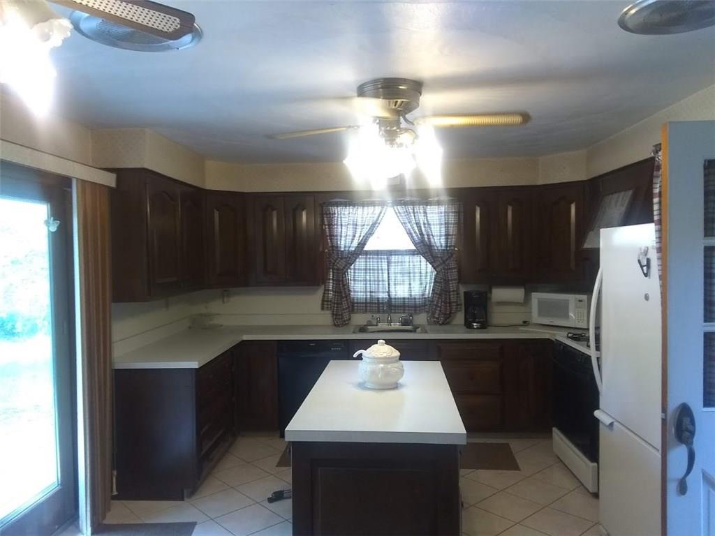 188 Metz Road Parker, PA 16049 - Photo 6 of 25 KITCHEN WITH ISLAND AND PATIO DOOR TO DECK