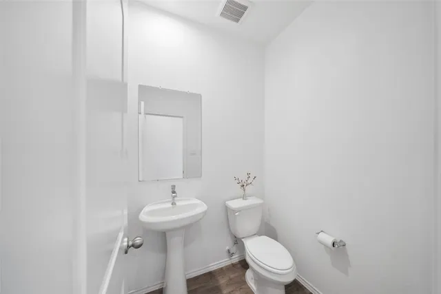 a bathroom with a sink a toilet and a mirror