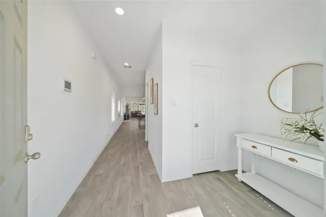 a view of a room with mirror and window