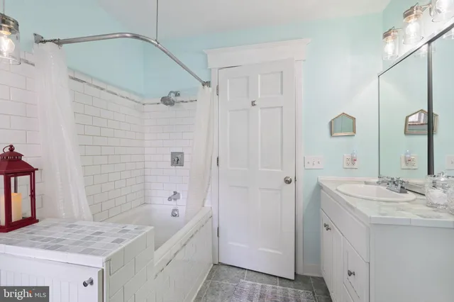 a bathroom with a granite countertop sink a shower and a mirror