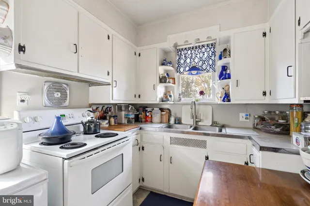 a kitchen with a sink stove and cabinets