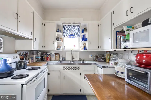 a kitchen with a sink stove and cabinets