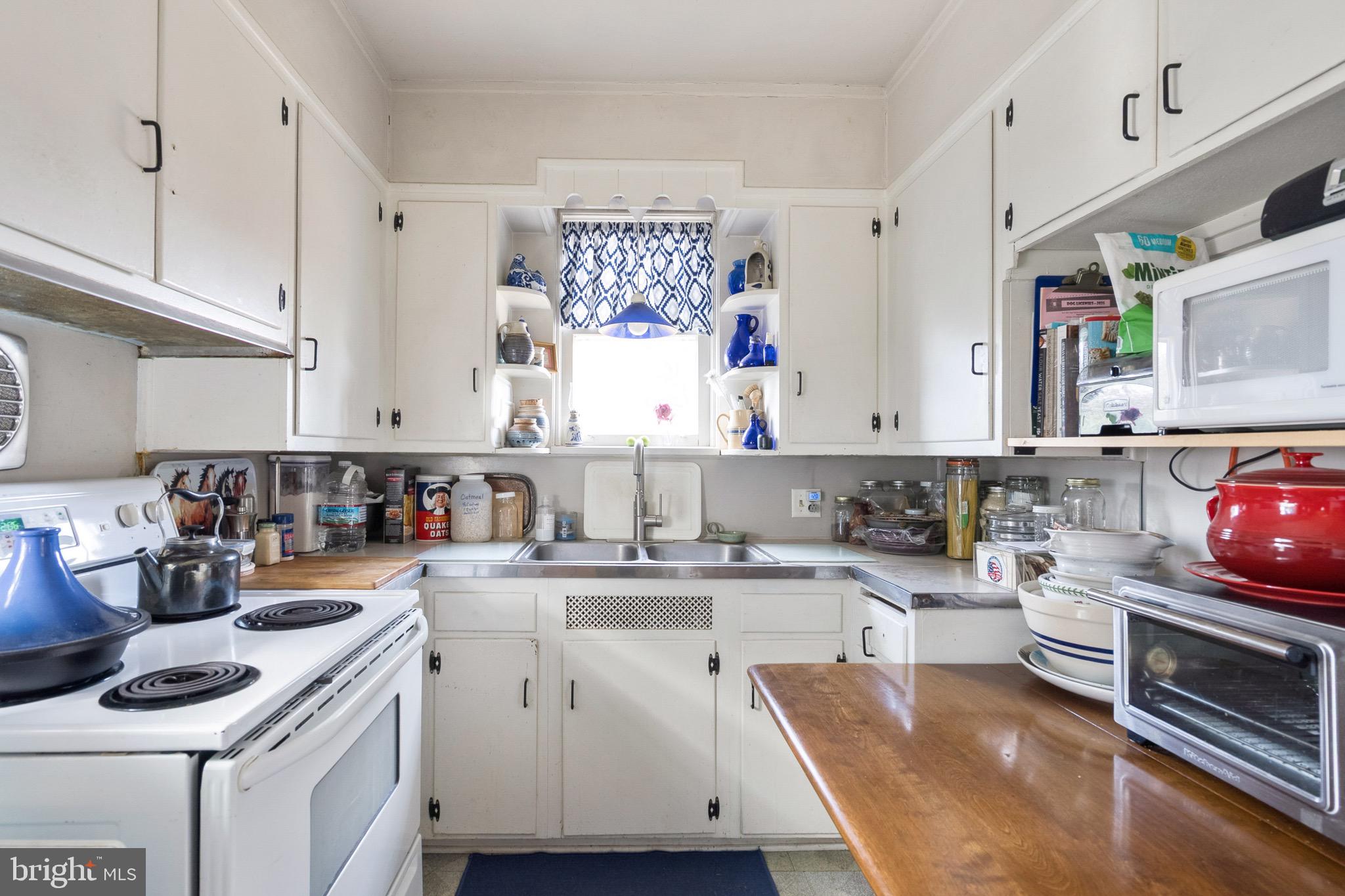 149 Highway 45 Mannington, NJ 08079 - Photo 14 of 24 a kitchen with a sink stove and cabinets