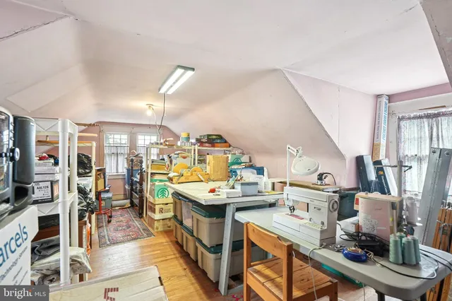 a room with stainless steel appliances kitchen island granite countertop a stove and a view of living room