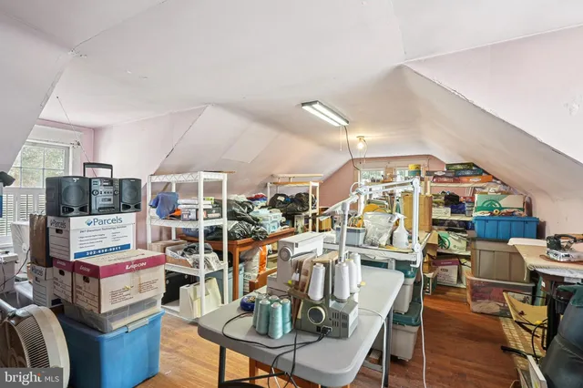 a view of a room with lots of furniture and clutter