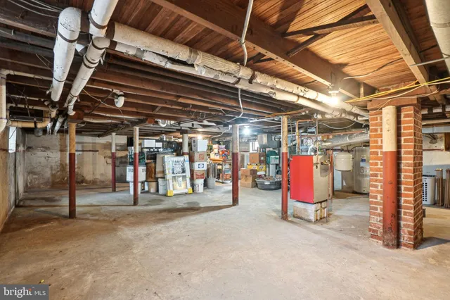 a front view of a house with a yard and large tree