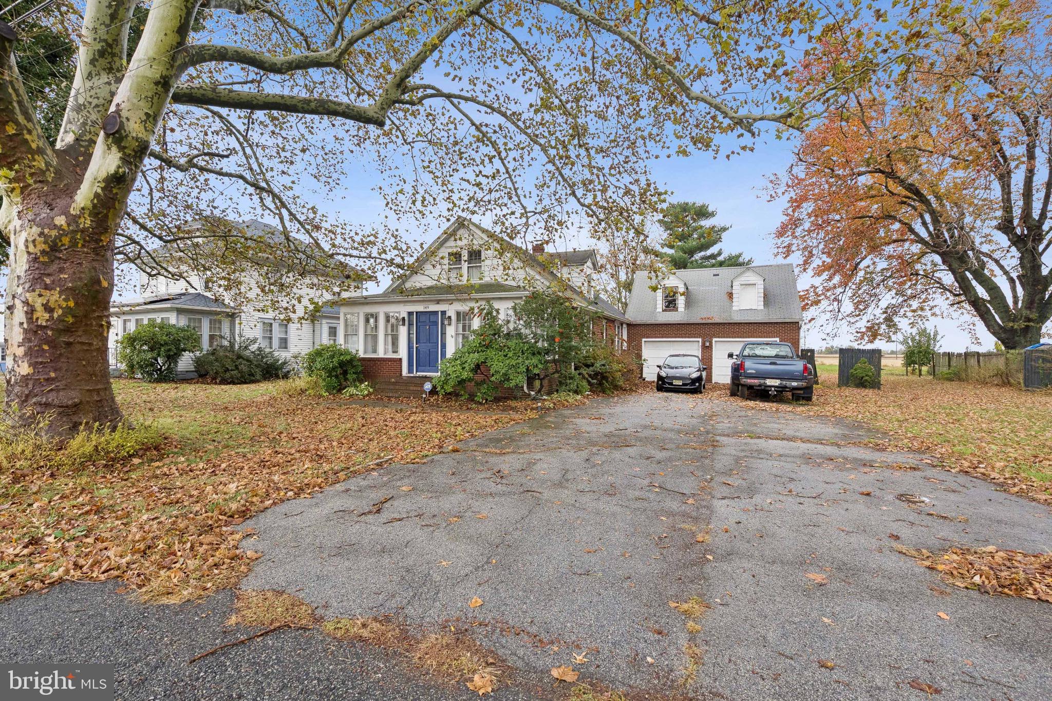 149 Highway 45 Mannington, NJ 08079 - Photo 22 of 24 a front view of a house with a yard and large tree