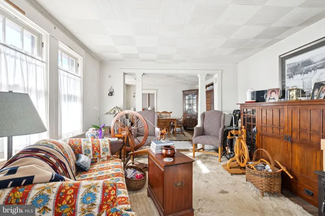 a living room with furniture a couch and large window