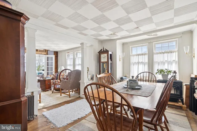 a dining room with furniture a rug and wooden floor