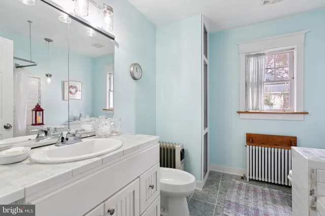 a bathroom with a sink toilet and a mirror