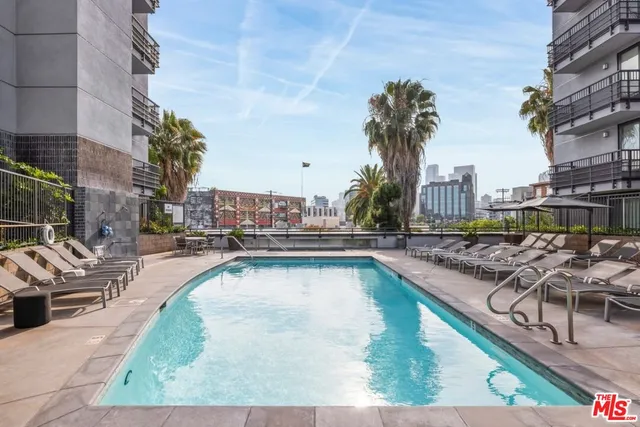 a view of a swimming pool with outdoor seating