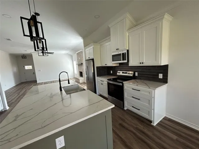 a kitchen with a refrigerator stove and microwave