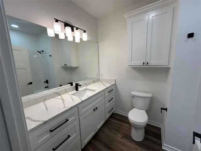 a bathroom with a toilet a sink and bathtub