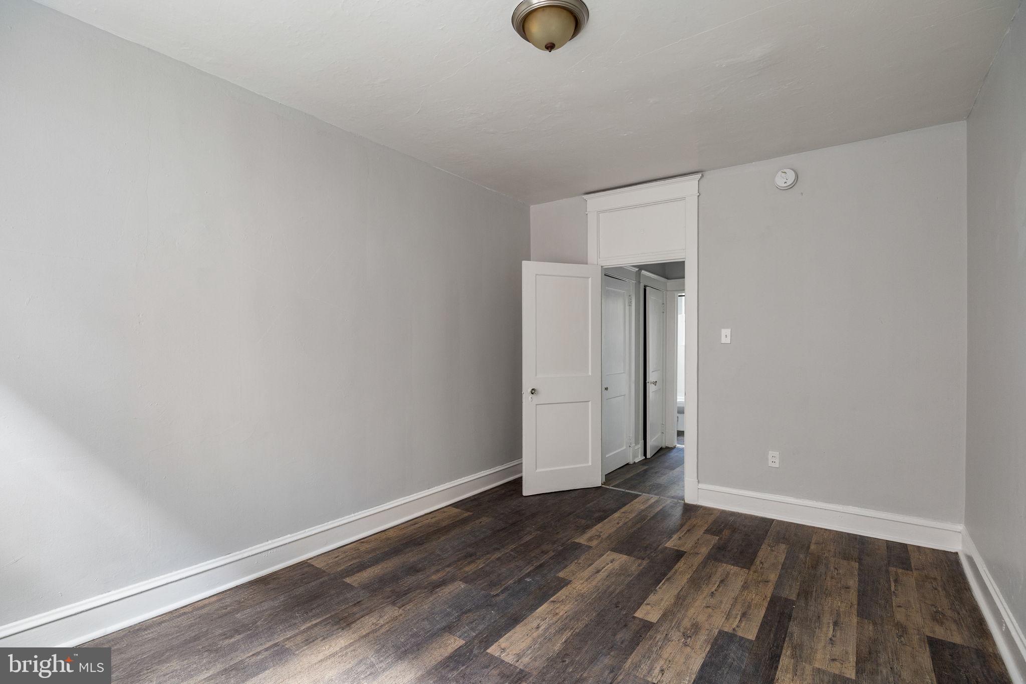 0 Garrett Road, Unit E201 Upper Darby, PA 19082 - Photo 14 of 19 a view of an empty room with wooden floor and closet