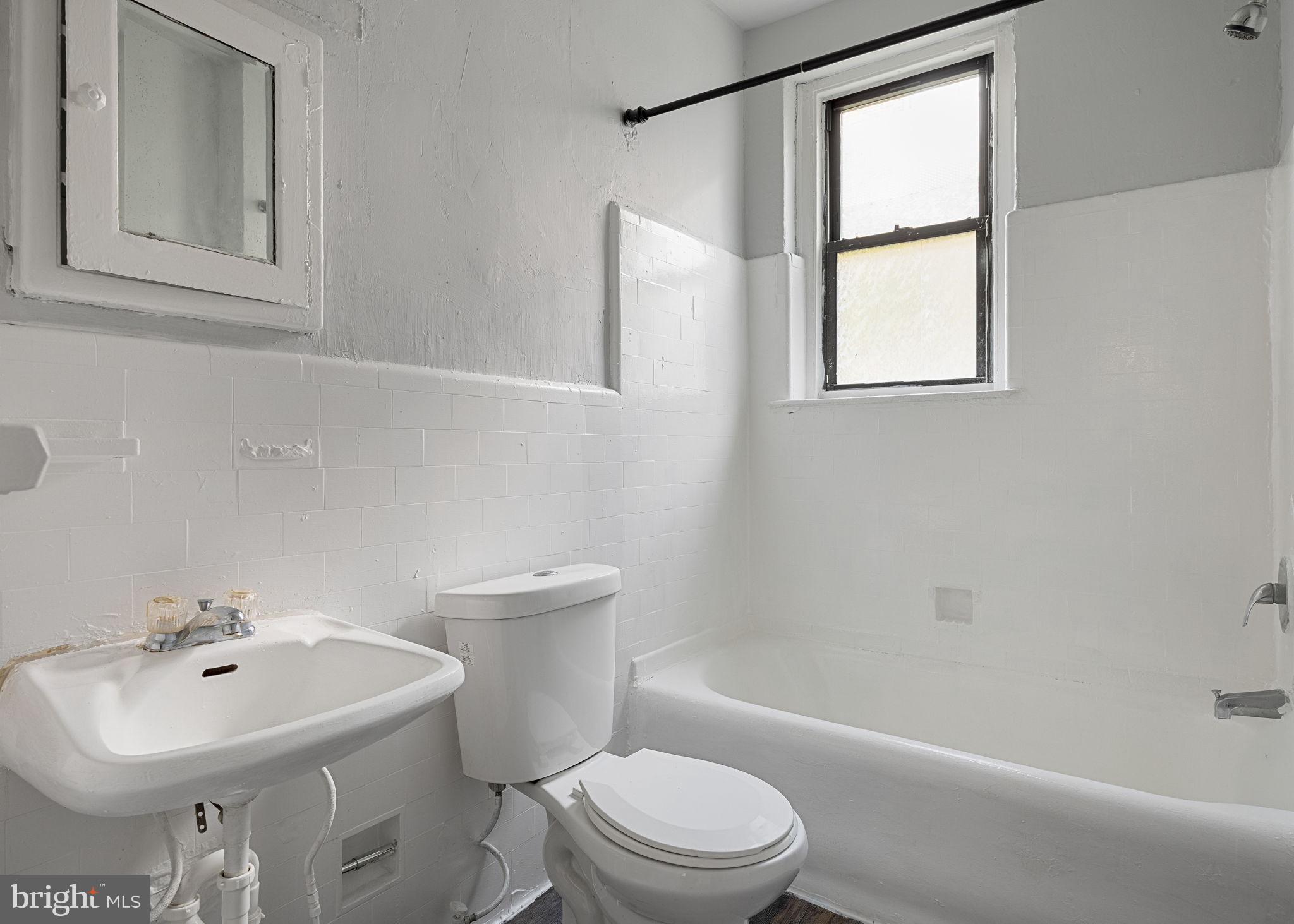 0 Garrett Road, Unit E201 Upper Darby, PA 19082 - Photo 15 of 19 a bathroom with a sink toilet and shower