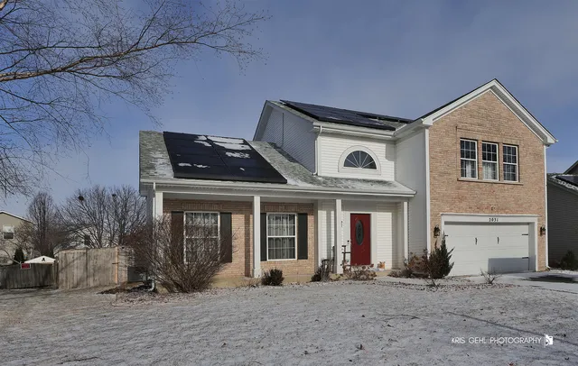 a front view of a house with a garden and plants