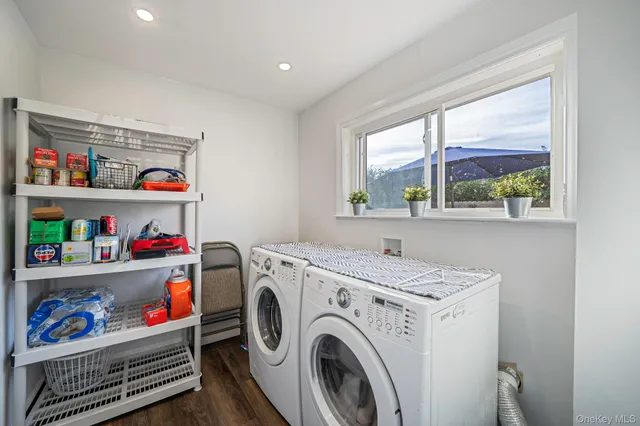 a utility room with dryer washer and a window
