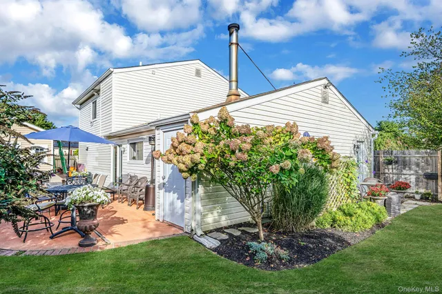 a view of a house with backyard porch and sitting area
