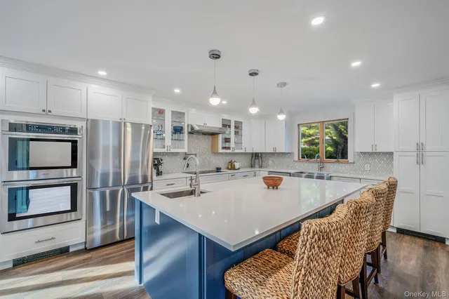 a large kitchen with a table and chairs
