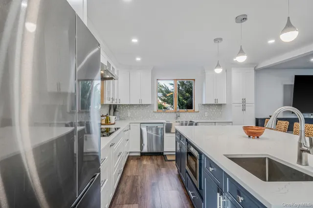 a kitchen with a sink stove top oven and cabinets