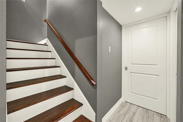 a kitchen with granite countertop a stove a sink and a refrigerator