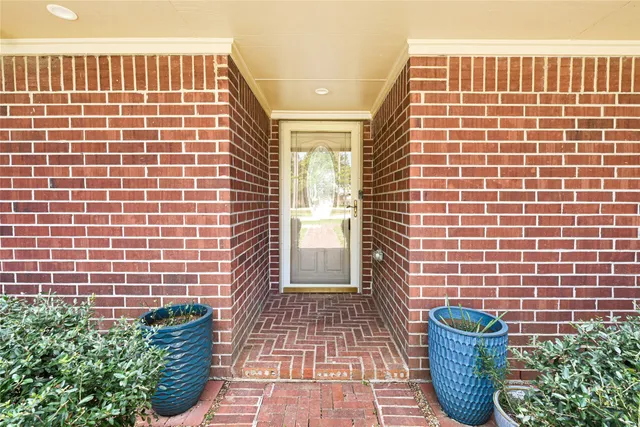 a view of empty room with wooden floor and windows