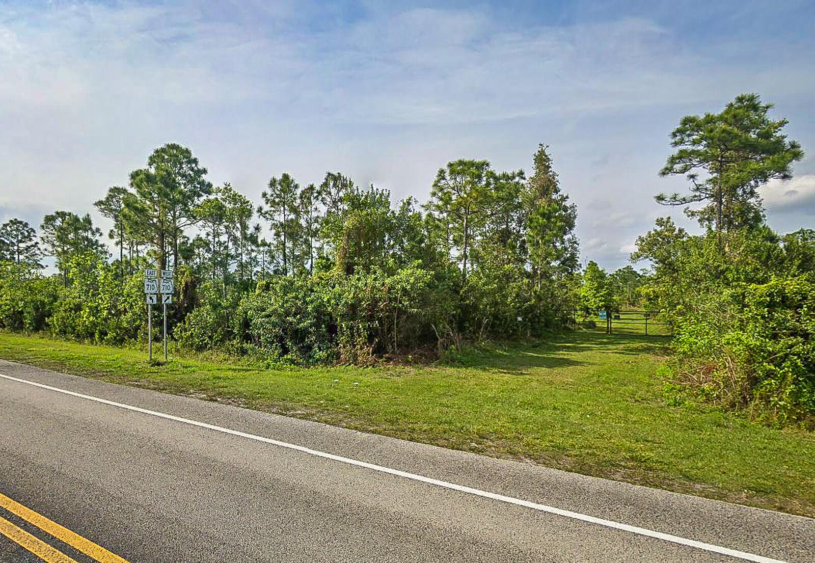 19791 West Indiantown Road Jupiter, FL 33478 - Photo 2 of 7 a yard with lots of green space and trees