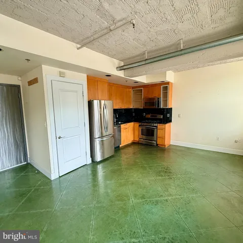 a bathroom with a granite countertop sink toilet and mirror