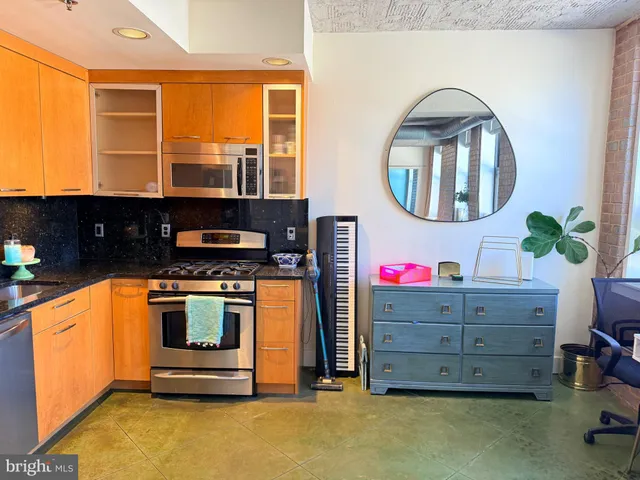 a stove top oven sitting inside of a kitchen