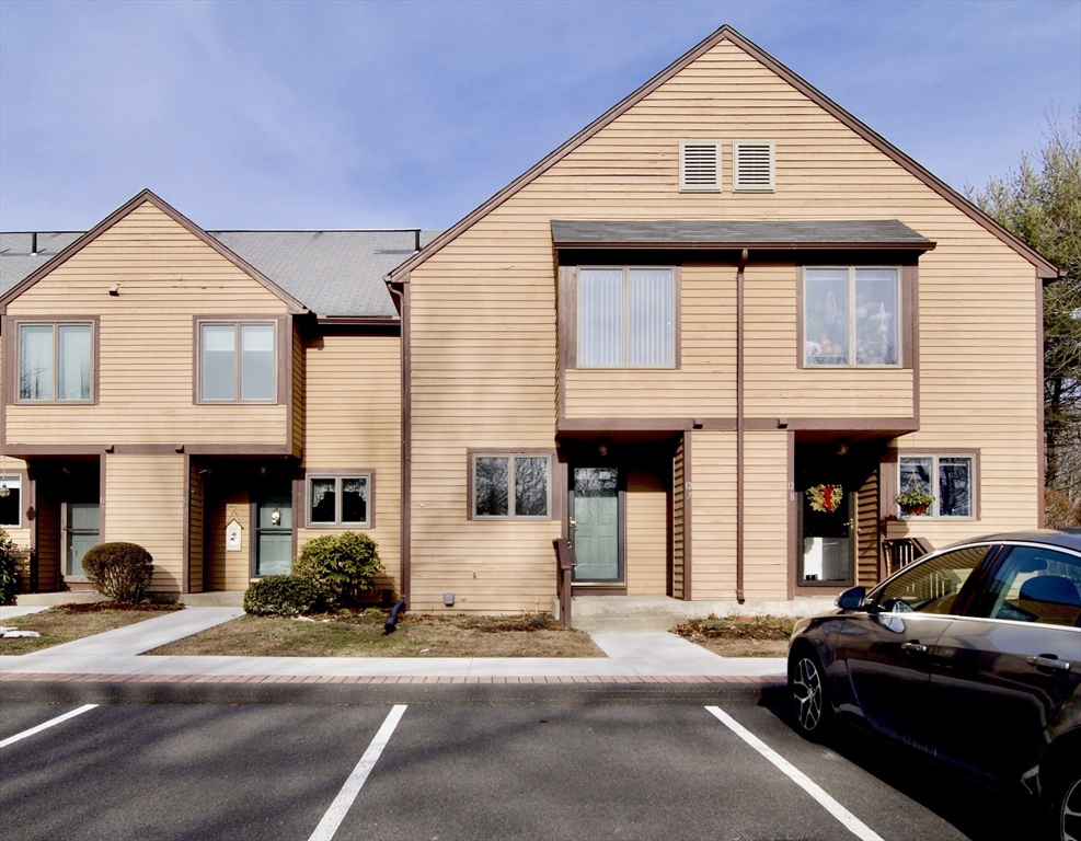 a view of a car park in front of a house
