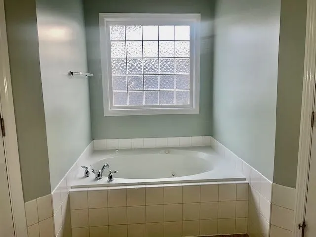 a bath tub sitting next to a window