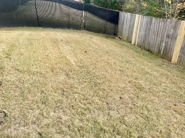 a view of an empty room with wooden fence