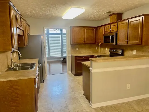 a kitchen that has a sink and a stove in it