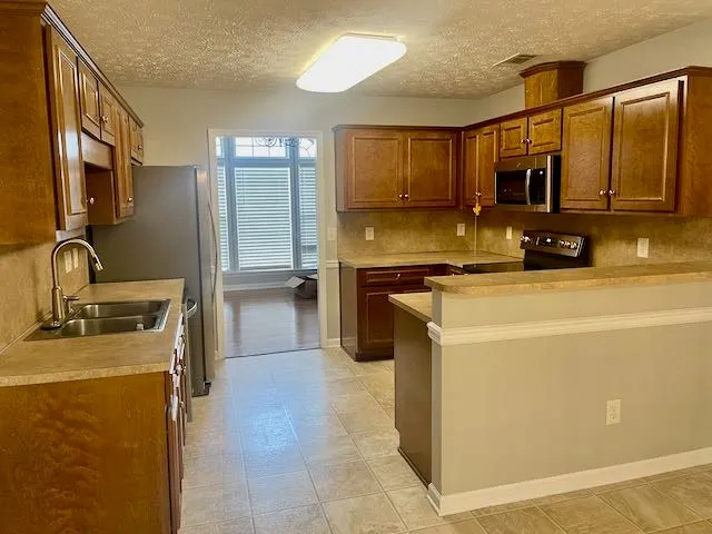 a kitchen that has a sink and a stove in it